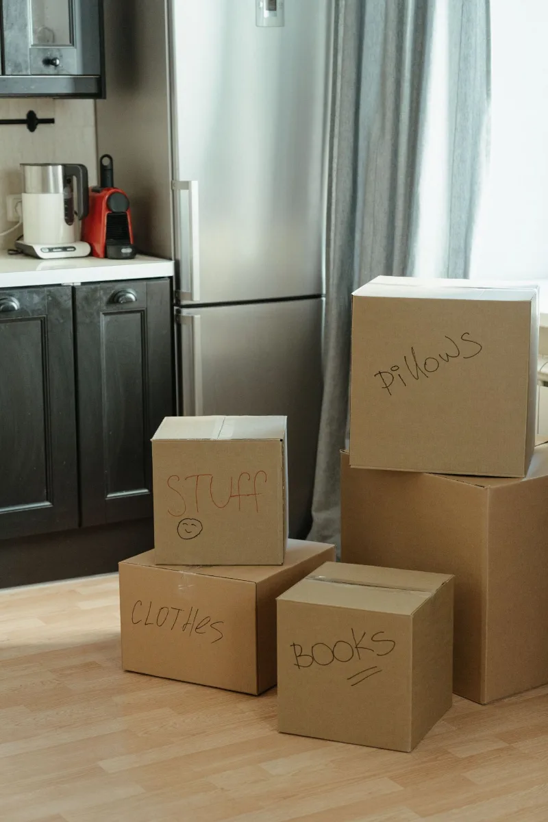 Labeled moving boxes in a kitchen on closing day for a new Texas home